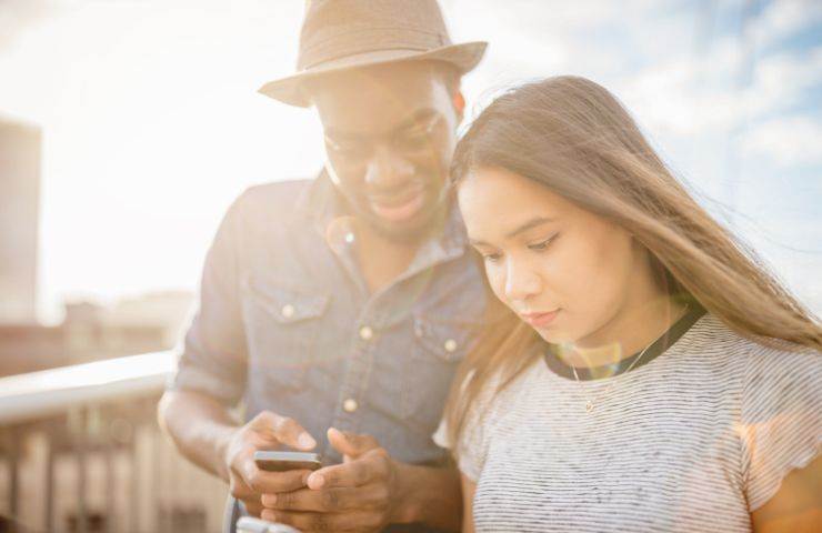 coppia con telefono in mano 